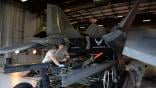 Air Force personnel work on an F119 engine