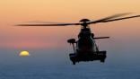 Helicopter flying against sunset