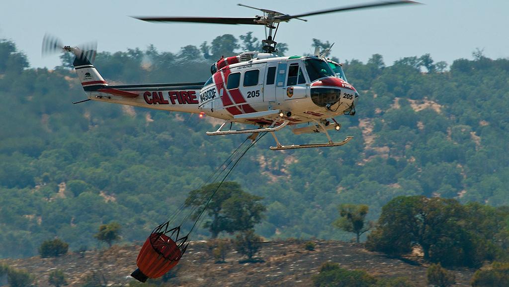 Cal Fire UH-1H Super Huey above a wildfire