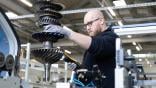 A technician services a Honeywell HGT1700 APU component at Lufthansa Technik.