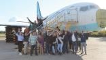 staffers posing in front of aircraft