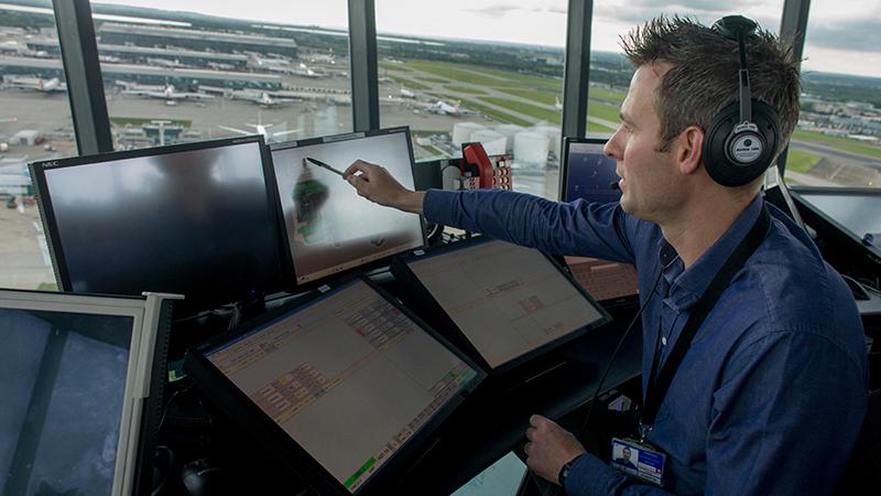 Air traffic controller in tower at London Heathrow Airport