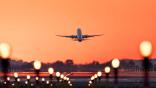 topsoe image of plane taking off at sunset