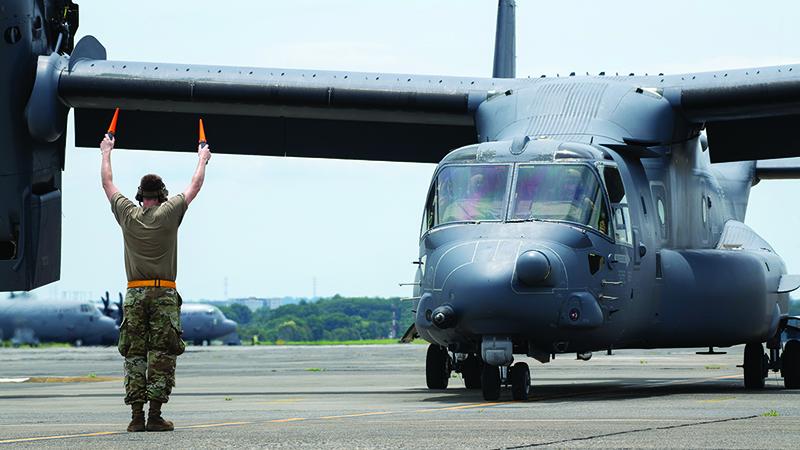 soldier marshals Bell Boeing CV-22 on runway