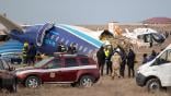 Broken Azerbaijan Airlines Flight 8243 fuselage surrounded by investigators